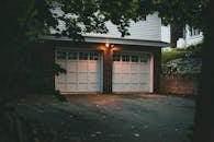 Warm evening view of a suburban garage with soft lighting creating a cozy atmosphere.